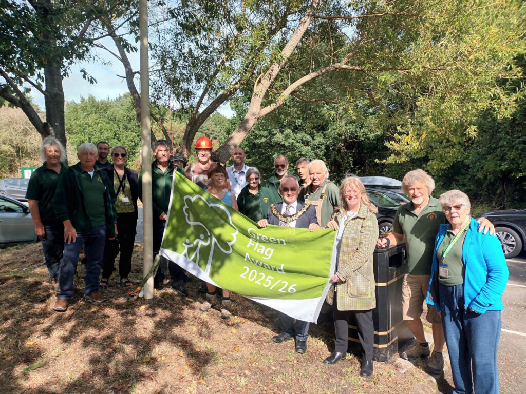 Photo of volunteers raising the Green Flag for Bidston Hill